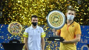 Belgium's David Goffin (R) poses with his trophy after winning the final of the ATP World Tour Open Sud de France tennis tournament against Spain's Roberto Bautista Agut (L) in Montpellier on February 28, 2021.  / AFP / Pascal GUYOT